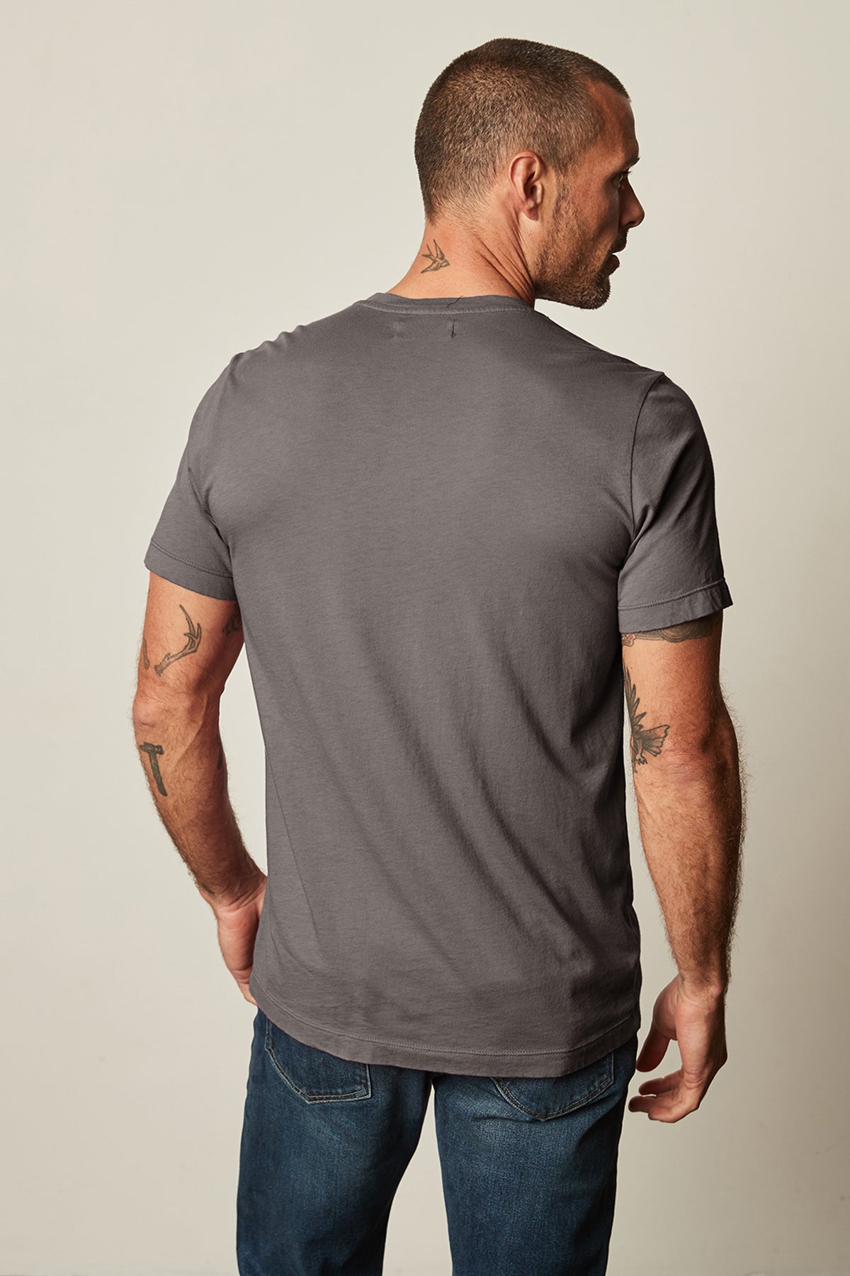 the back of a man wearing jeans and a Velvet by Graham & Spencer SAMSEN WHISPER CLASSIC V-NECK TEE.-25793906049217