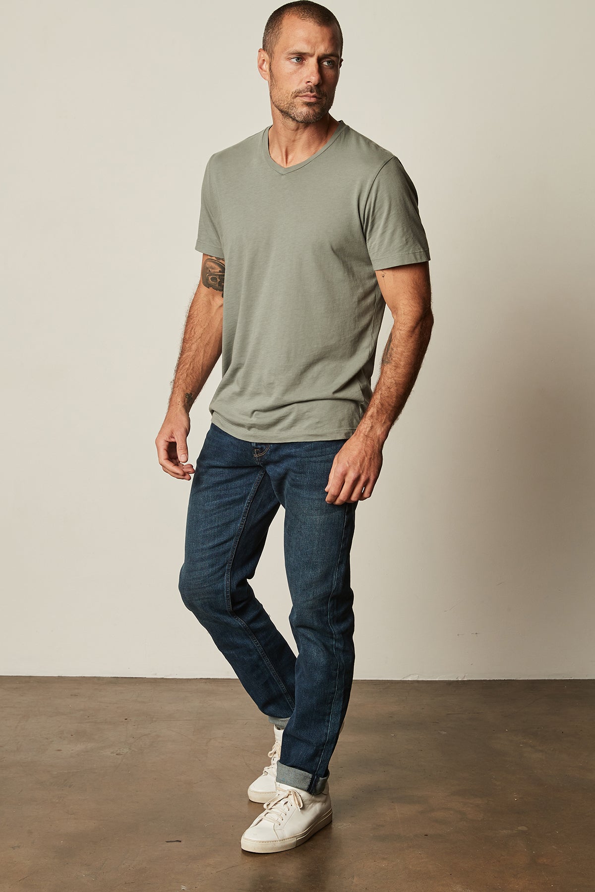 a man wearing a Velvet by Graham & Spencer SAMSEN WHISPER CLASSIC V-NECK TEE and jeans.-25793905819841