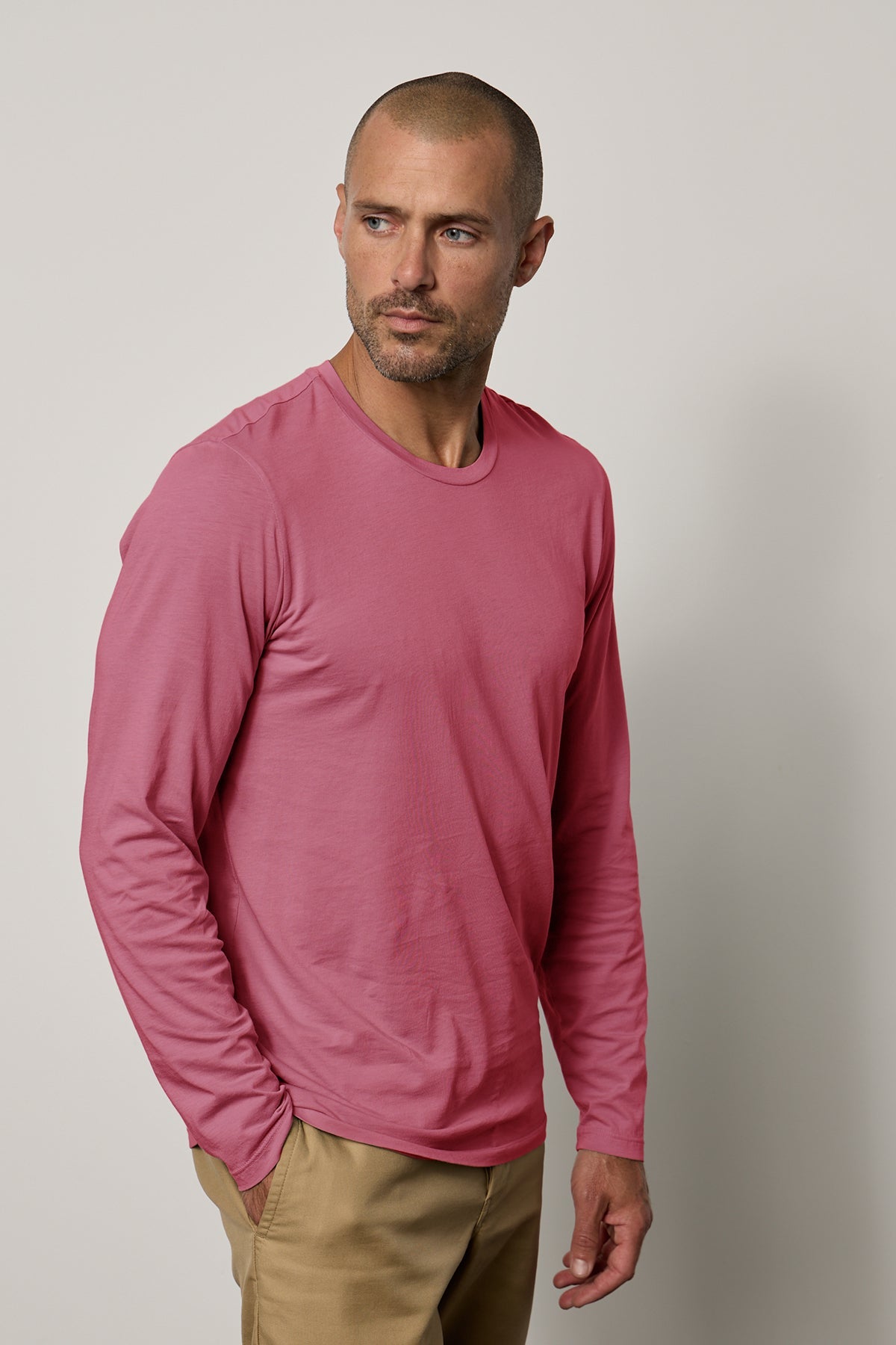 A man wearing a Velvet by Graham & Spencer SKEETER WHISPER CLASSIC CREW NECK TEE.-25794009530561