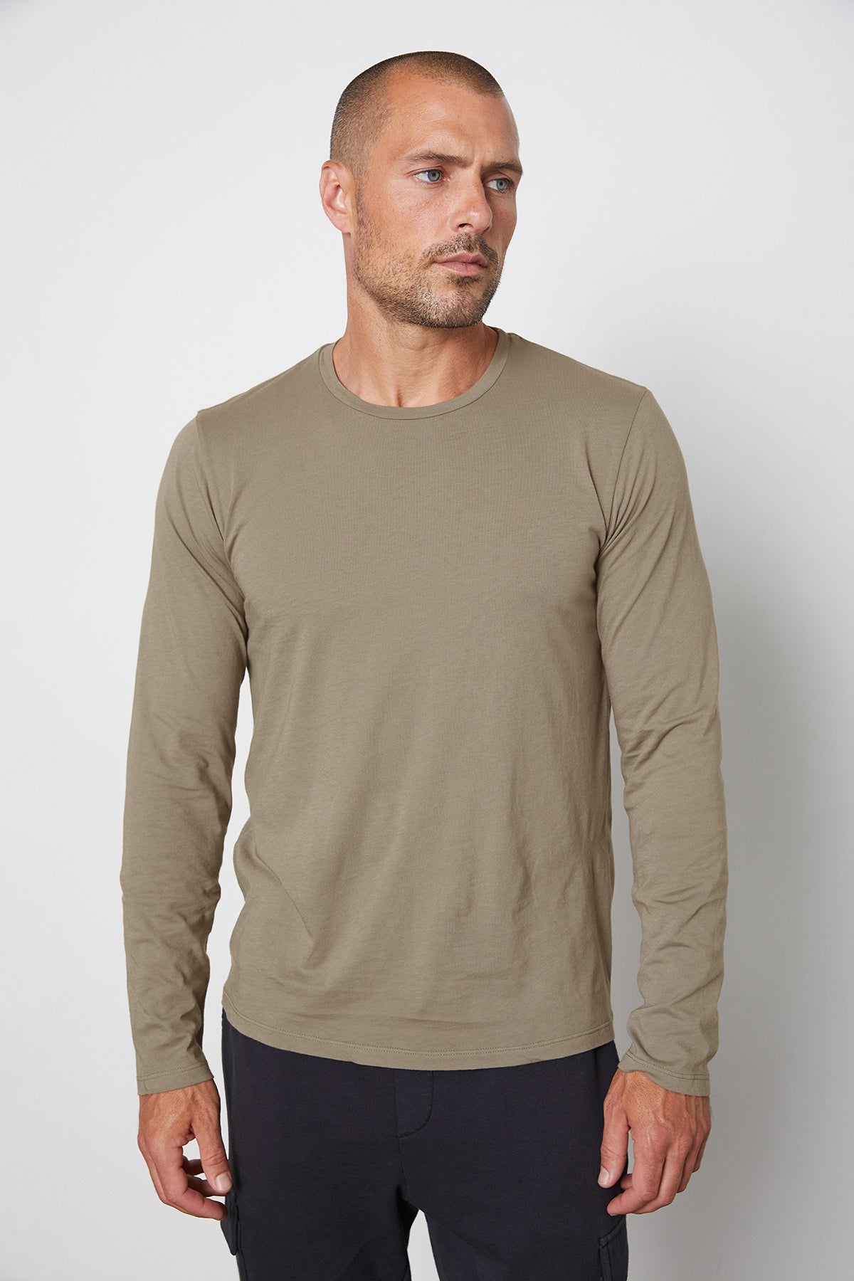 A man wearing a Velvet by Graham & Spencer SKEETER WHISPER CLASSIC CREW NECK TEE.-25794008842433