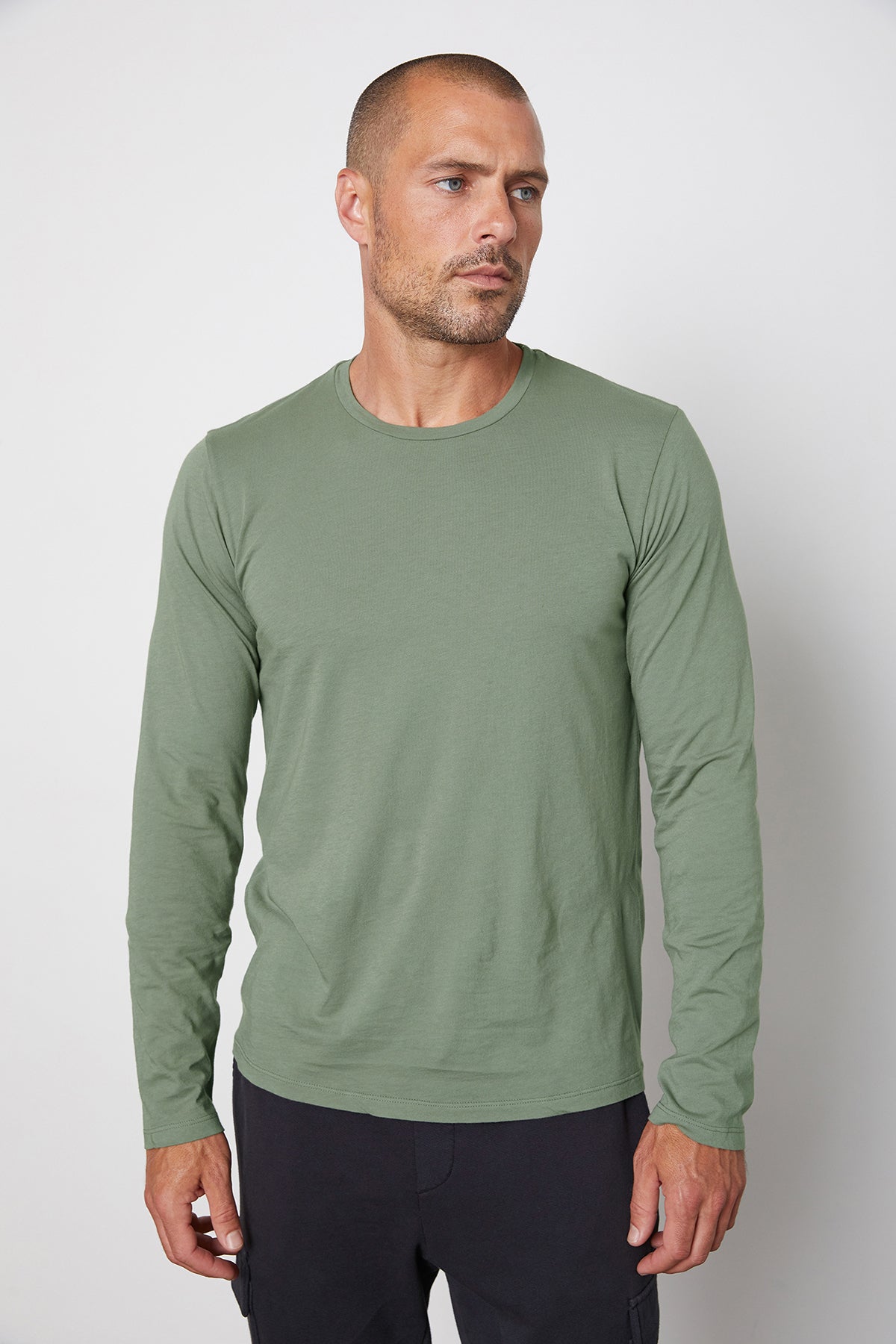 A man wearing a Velvet by Graham & Spencer SKEETER WHISPER CLASSIC CREW NECK TEE.-25794009039041