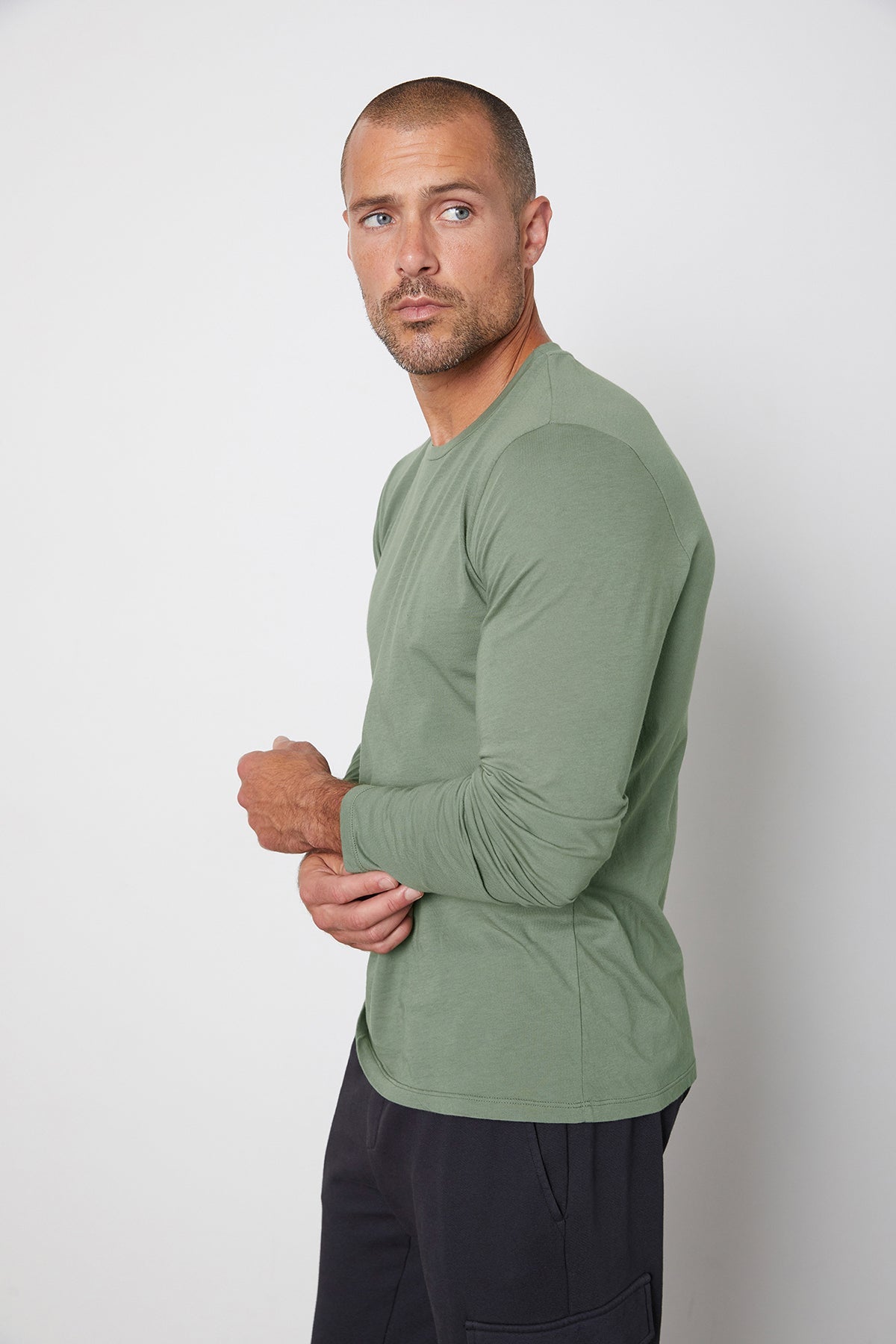   A man wearing a Velvet by Graham & Spencer SKEETER WHISPER CLASSIC CREW NECK TEE green long sleeve t - shirt. 