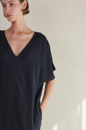 The model is wearing a black MONTANA DRESS by Velvet by Jenny Graham.