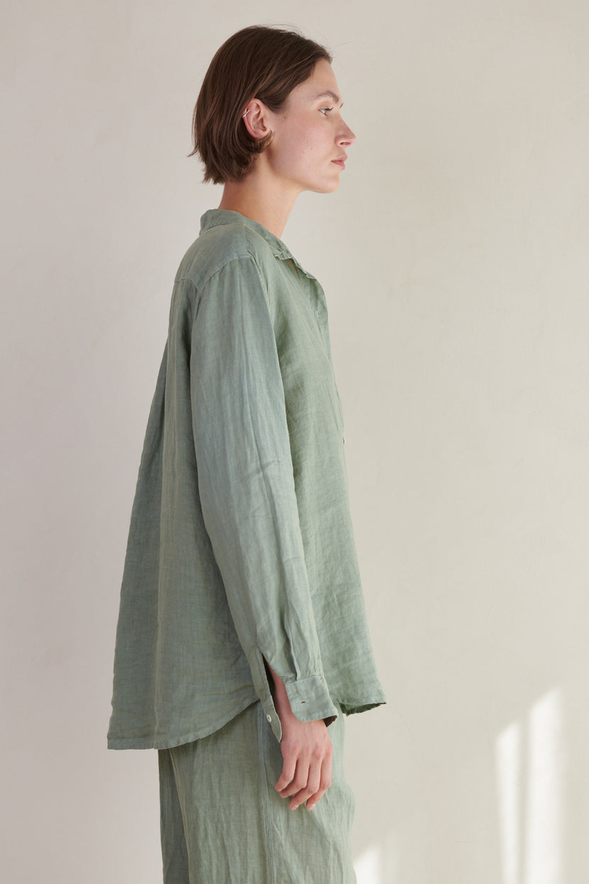a woman wearing a Green Linen MULHOLLAND SHIRT by Velvet by Jenny Graham and pants.
