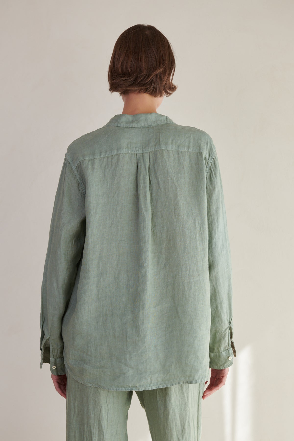 the back view of a woman wearing a Velvet by Jenny Graham Mulholland Shirt and pants.-26293074690241