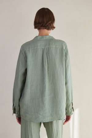the back view of a woman wearing a Velvet by Jenny Graham Mulholland Shirt and pants.