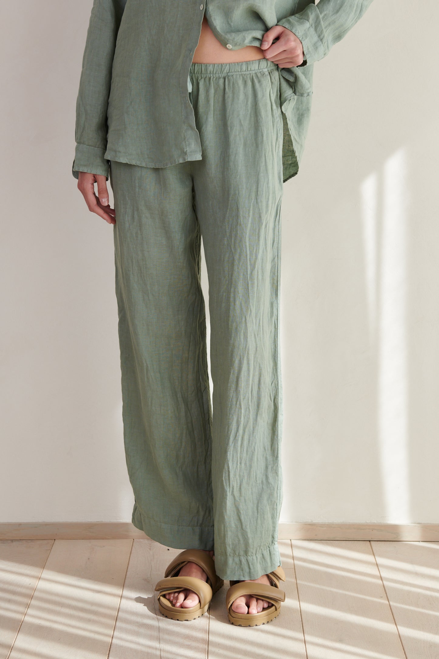 A woman wearing green Velvet by Jenny Graham PICO pants and sandals.-26293120532673