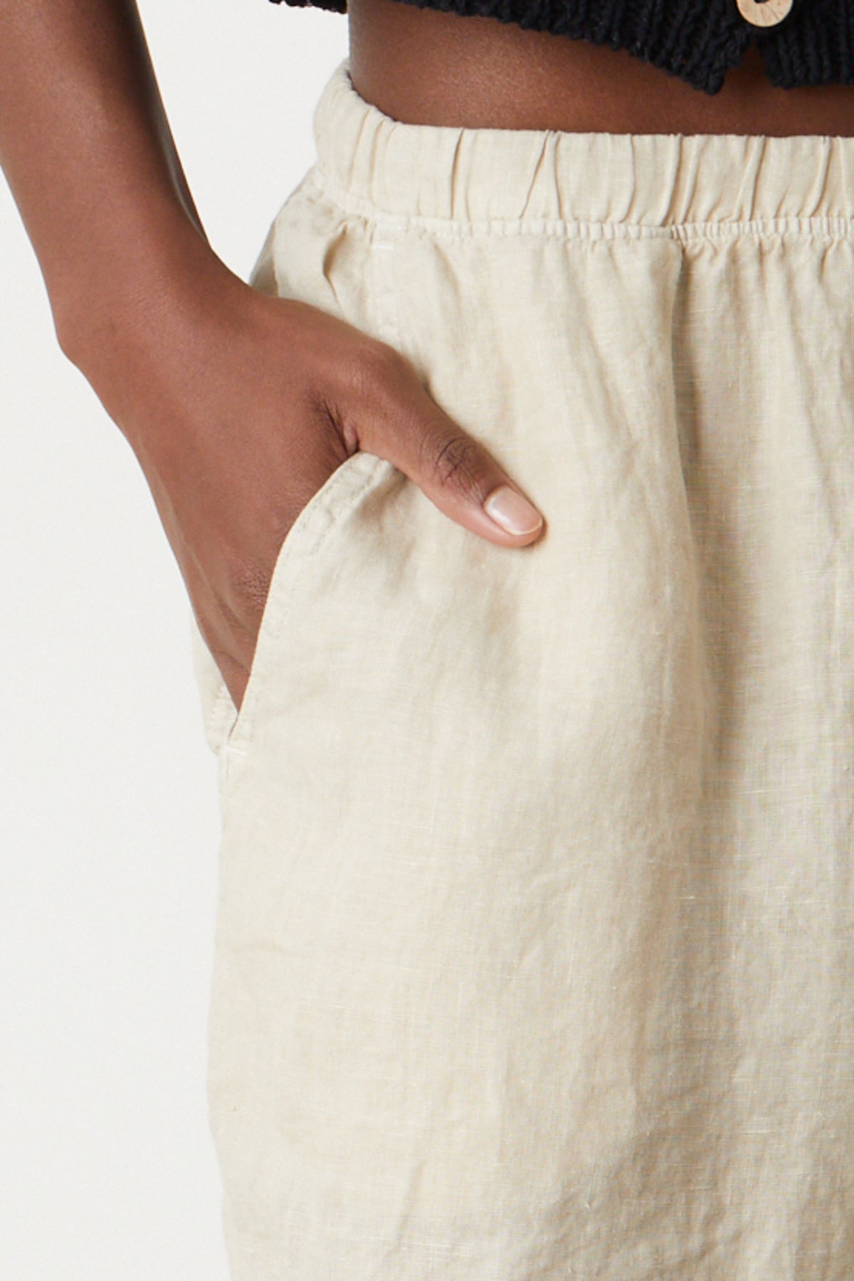   Tammy Short in sand colored woven linen close up detail with model's hand in pocket 