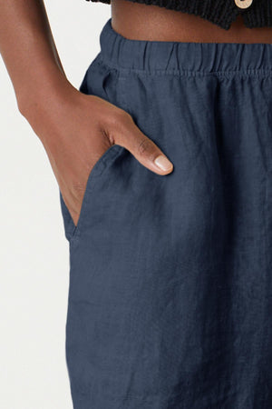 Tammy Short in shadow dark blue colored woven linen close up detail with model's hand in pocket