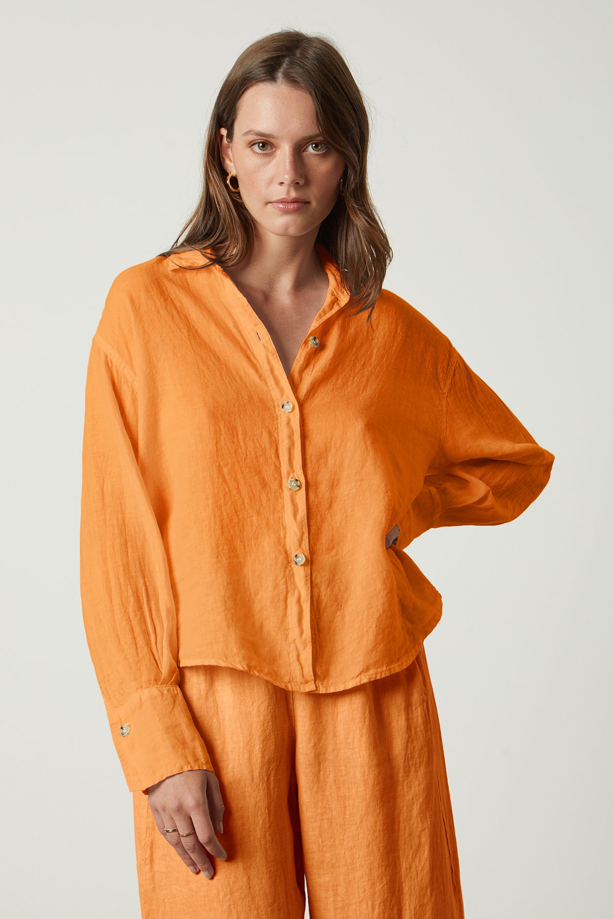 Eden button up shirt in orange heat with Lola pant front model hand on hip-26094866006209