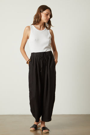 Hannah Linen Pant in black with Maxie tank in sand tucked full length front model hands in both pockets full length front