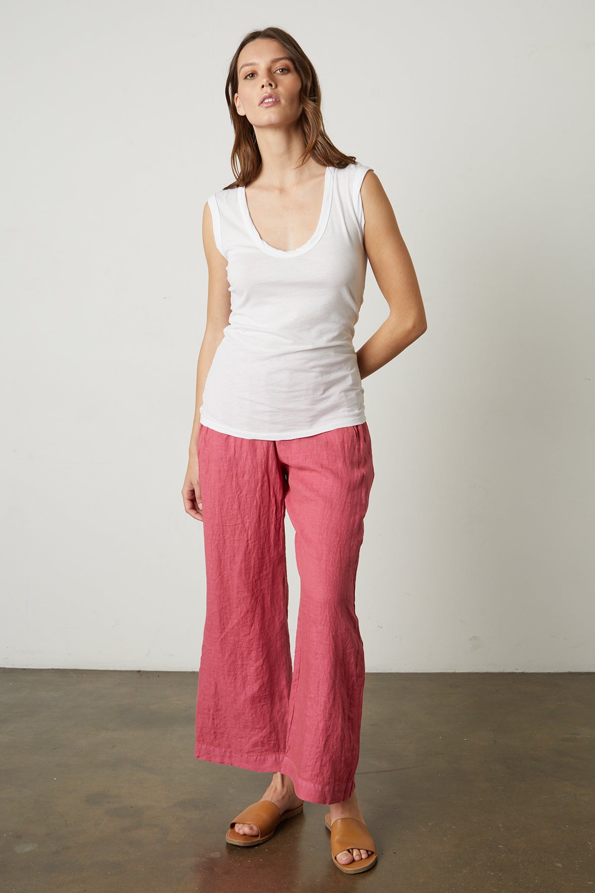   Model standing wearing Lola linen pant in calypso and Estina tank in white 