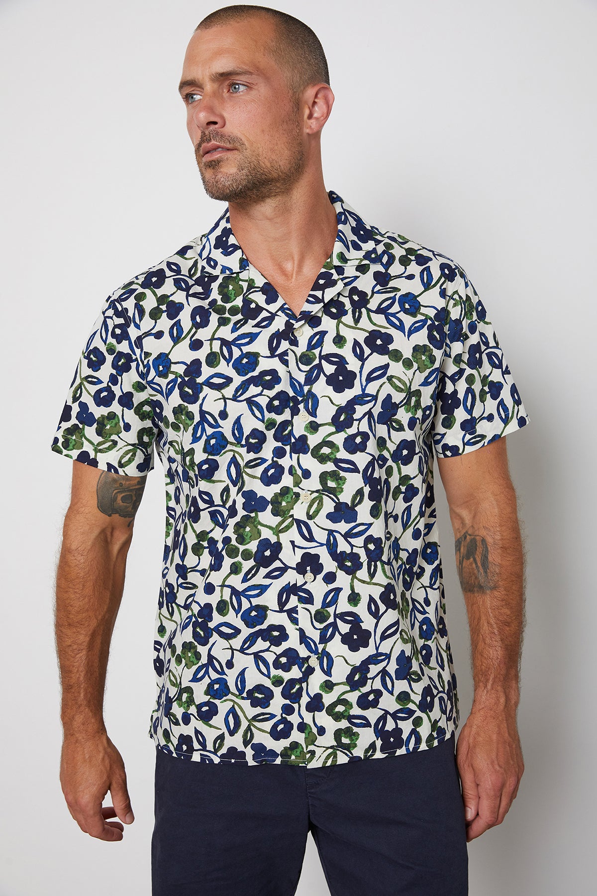   Isaiah button up printed shirt with navy and green flourishes paired with Louis short in navy. 