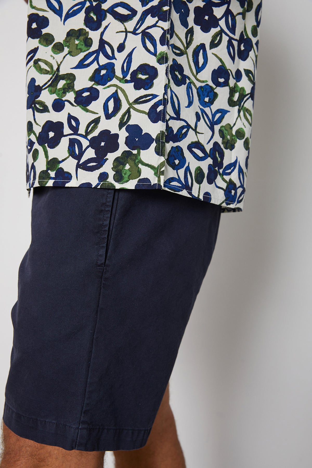 Side hem detail of Isaiah button up printed shirt with navy and green flourishes.-24605766320321