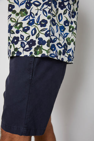 Side hem detail of Isaiah button up printed shirt with navy and green flourishes.