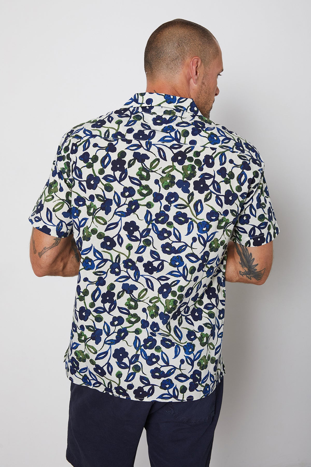   Back view of Isaiah button up shirt with navy and green flourishes, paired with Louis short in navy. 
