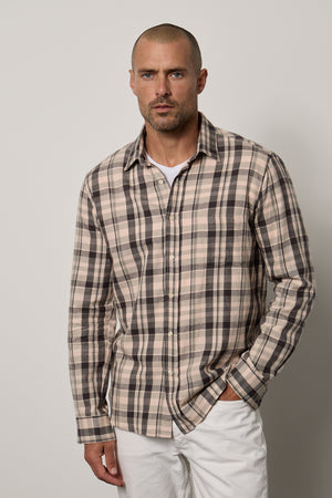 a man wearing a LEONARD PLAID BUTTON-UP SHIRT by Velvet by Graham & Spencer and white pants.